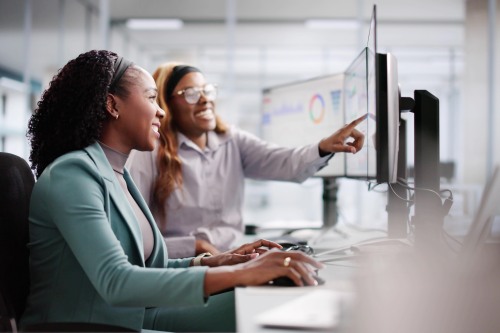 image of two women looking at data on a computer